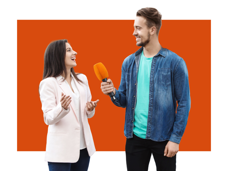 Woman and man standing with a microphone 