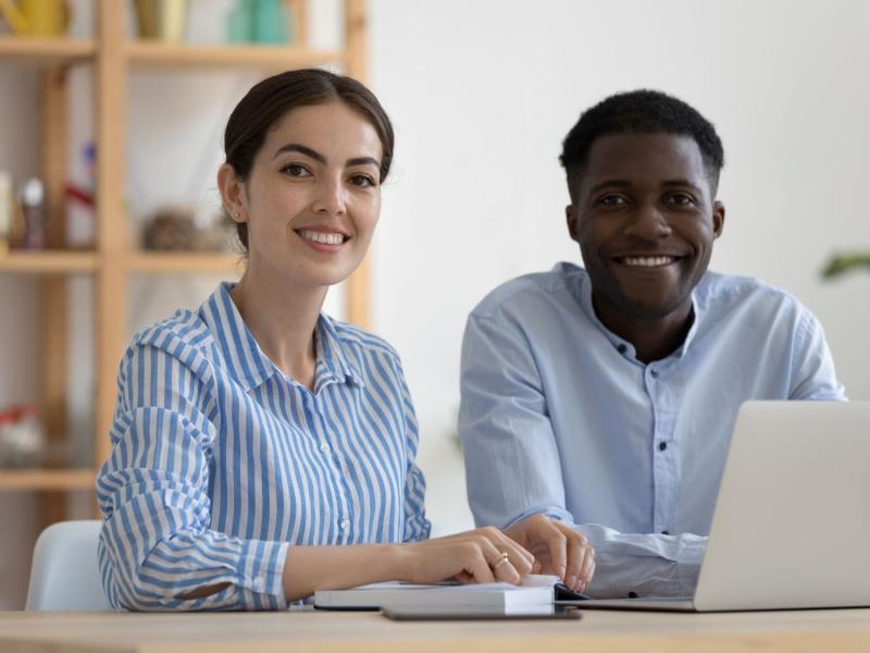 Two people looking at the camera smiling