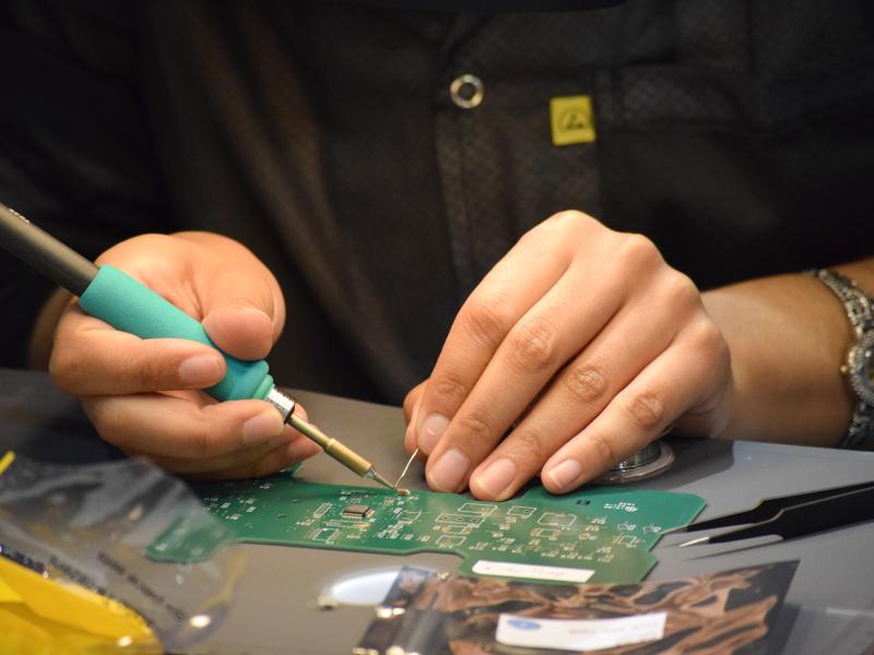 Hands Soldering a Printed Circuit Board