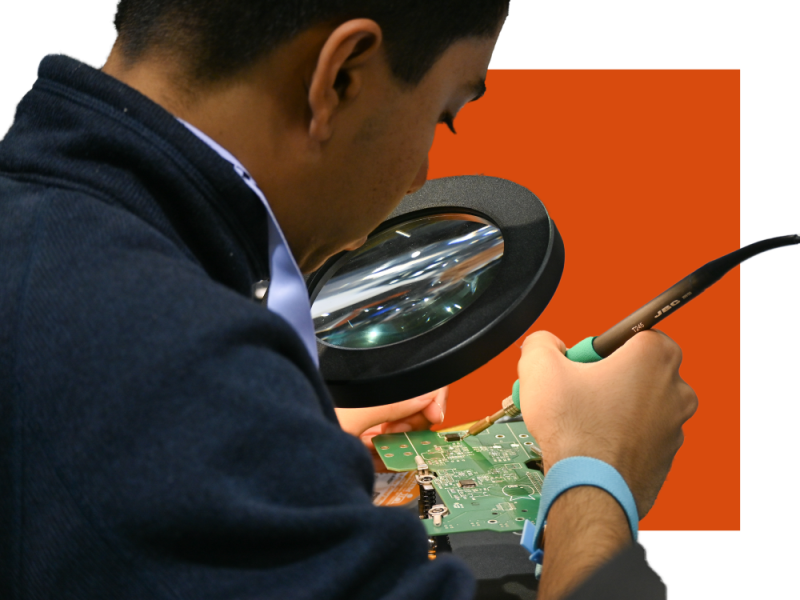 Student Soldering a Printed Circuit Board