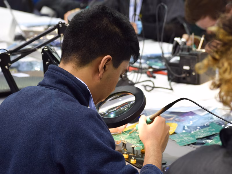 Student soldering a circuit board