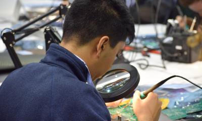 Man working on a PCB robot