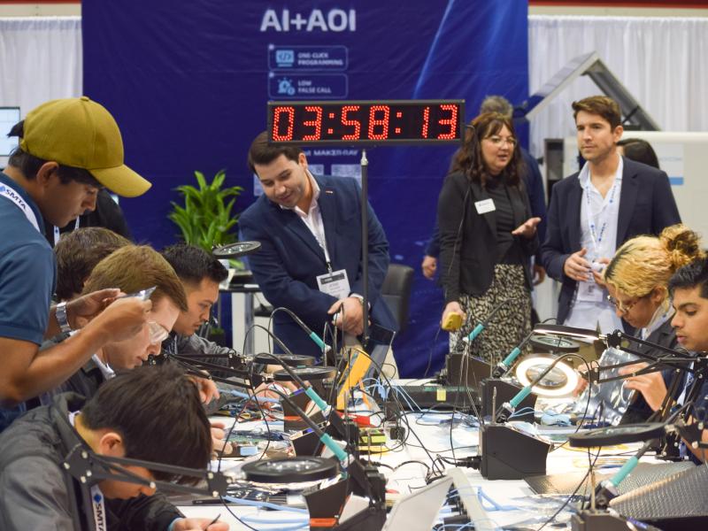 Students soldering robots