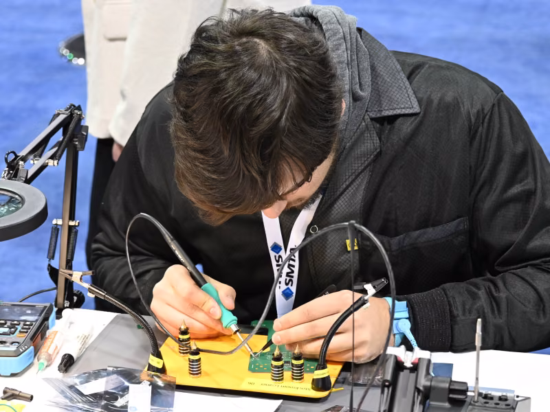 Student soldering circuit board