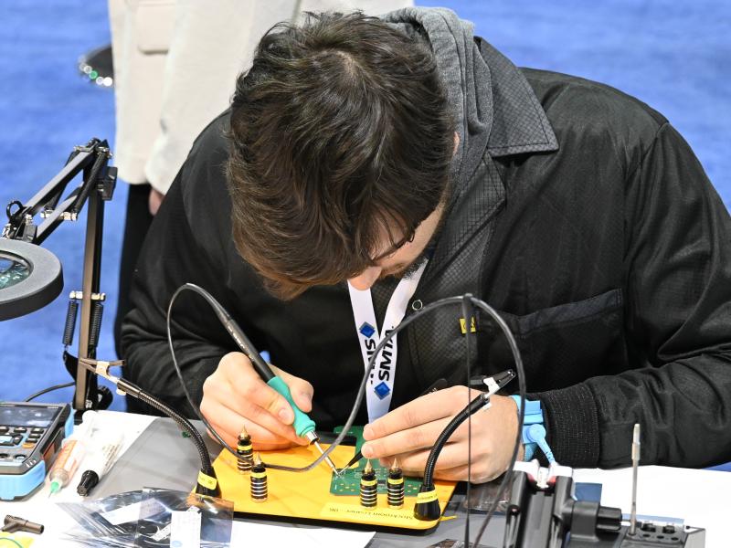 Student soldering circuit board