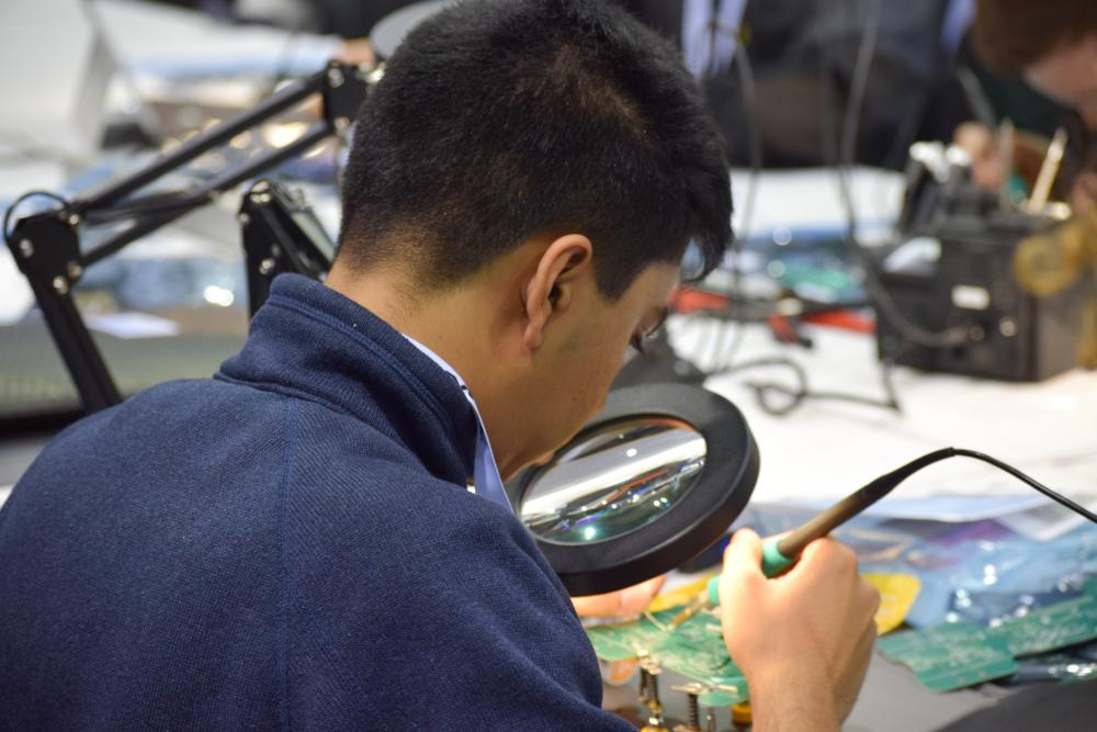 Man working on a PCB robot