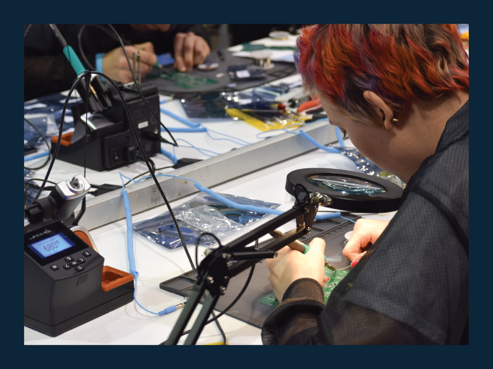 Student working on soldering a printed circuit board