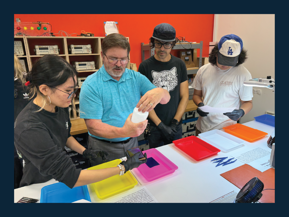 Students gathered around a teacher showing them defects in manufacturing