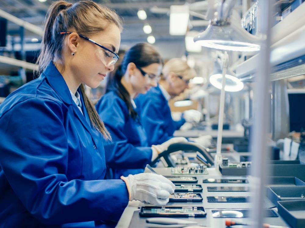 Electronics Manufacturing workers with circuit boards
