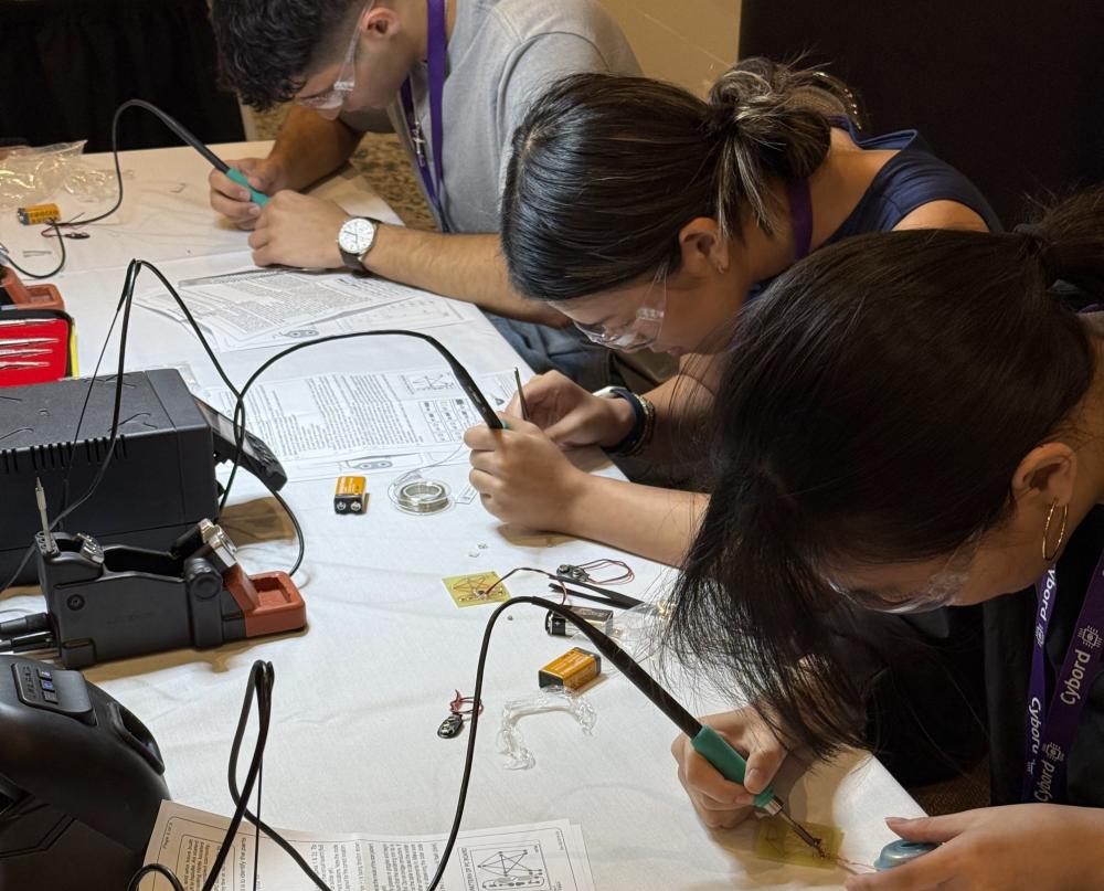 students soldering printed circuit boards